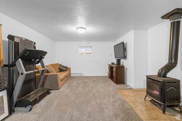 180 W 300 S, Fillmore, UT 84631 - workout area with a baseboard heating unit, a wood stove, light colored carpet, and a textured ceiling