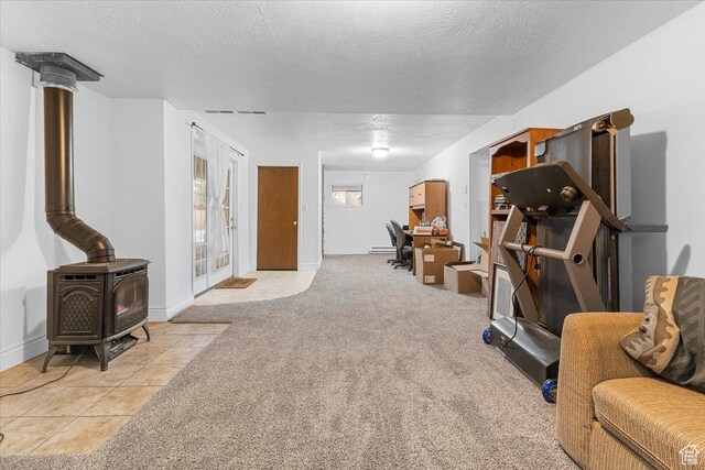 180 W 300 S, Fillmore, UT 84631 - exercise room featuring light colored carpet, a textured ceiling, and a wood stove