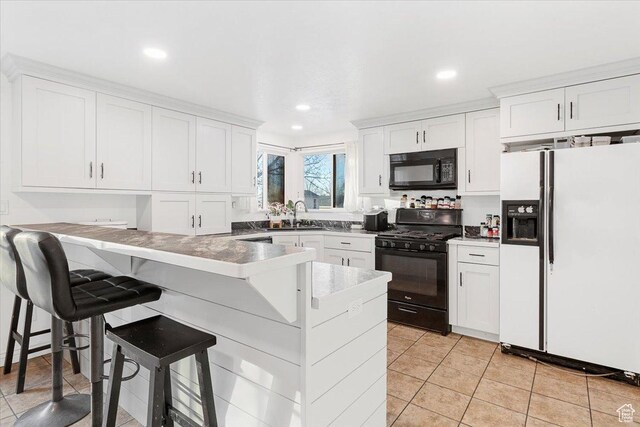 180 W 300 S, Fillmore, UT 84631 - kitchen with white cabinetry, sink, a kitchen bar, and black appliances