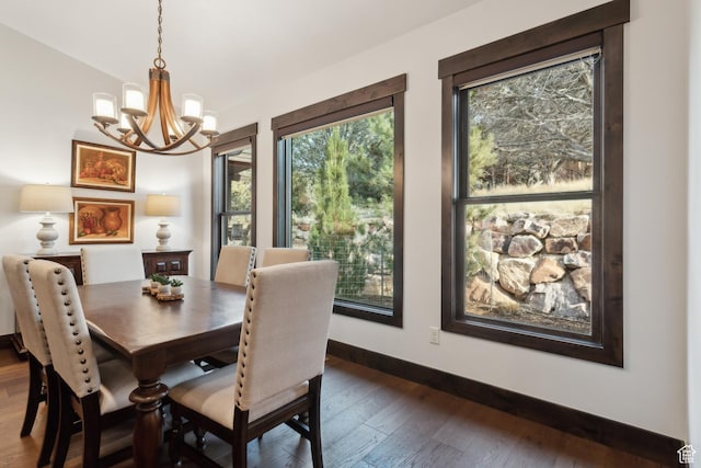 dining area featuring dark hardwood / wood-style floors and a notable chandelier