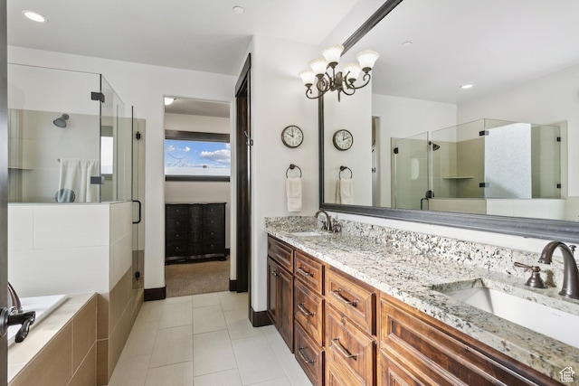 bathroom featuring vanity, tile patterned floors, a chandelier, and plus walk in shower