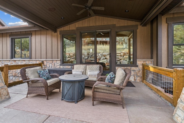 view of patio with ceiling fan and an outdoor living space with a fire pit