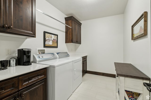 laundry room featuring washing machine and dryer and cabinets