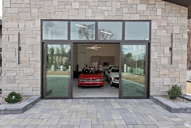property entrance with stone siding