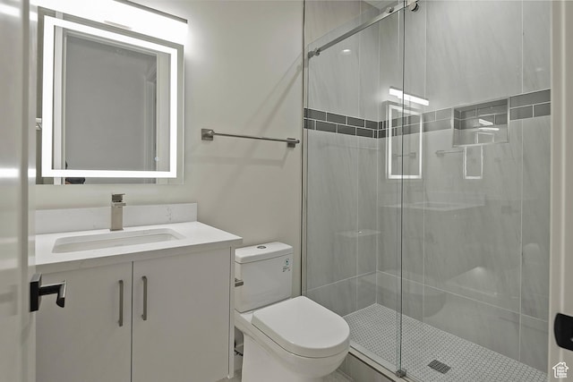 full bathroom with vanity, toilet, and a shower stall