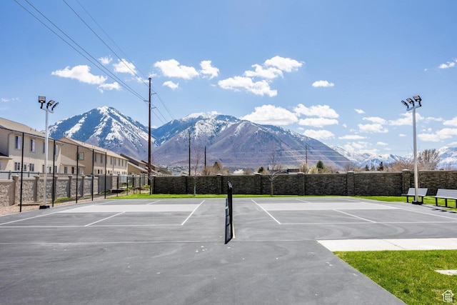 view of sport court with a mountain view and basketball hoop