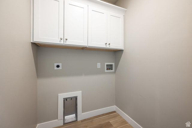 clothes washing area featuring cabinets, hookup for an electric dryer, light hardwood / wood-style floors, and hookup for a washing machine