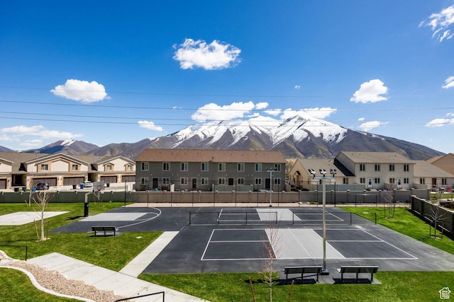 exterior space with a yard, a mountain view, basketball court, and tennis court