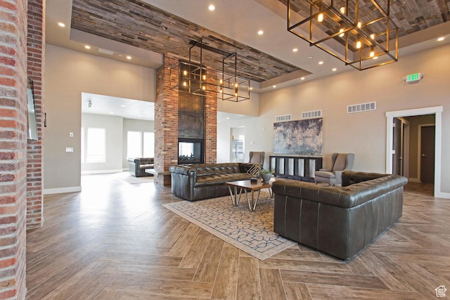 living room featuring parquet floors, a fireplace, and a high ceiling
