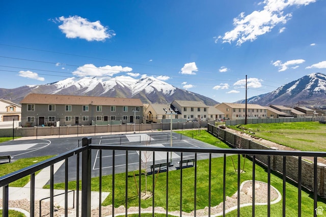 balcony featuring a mountain view and basketball court