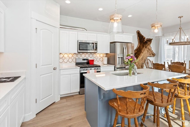 1088 N Freeman Dr, Saratoga Springs, UT 84045 - kitchen with recessed lighting, backsplash, hanging light fixtures, appliances with stainless steel finishes, and a breakfast bar area