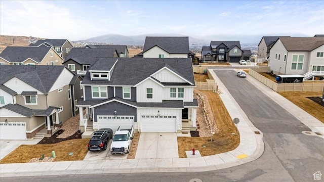 1088 N Freeman Dr, Saratoga Springs, UT 84045 - view of front of home with a residential view, board and batten siding, an attached garage, driveway, and roof with shingles