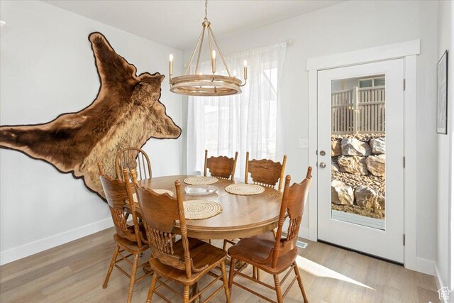 1088 N Freeman Dr, Saratoga Springs, UT 84045 - dining area featuring light wood-type flooring, baseboards, and a notable chandelier