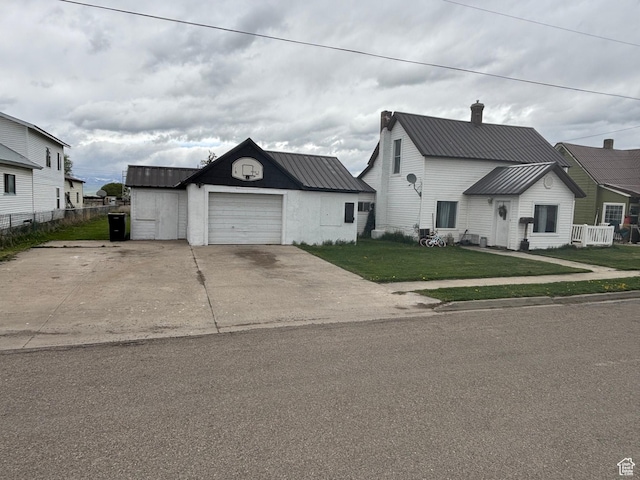 353 S 9th St, Montpelier, ID 83254 - view of front facade with concrete driveway, metal roof, a chimney, and an attached garage