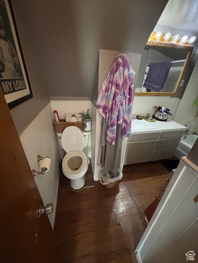 353 S 9th St, Montpelier, ID 83254 - bathroom with wood finished floors, wainscoting, toilet, and vanity