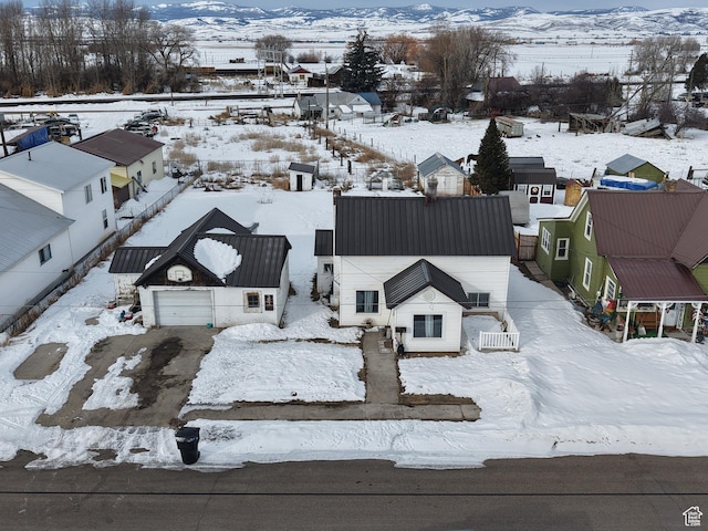 353 S 9th St, Montpelier, ID 83254 - snowy aerial view featuring a mountain view and a residential view