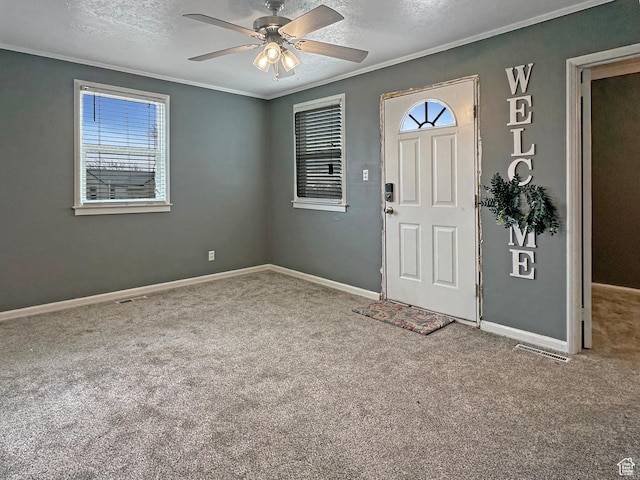 117 Grassy Dr, East Carbon, UT 84520 - carpeted entryway featuring crown molding, ceiling fan, and a textured ceiling