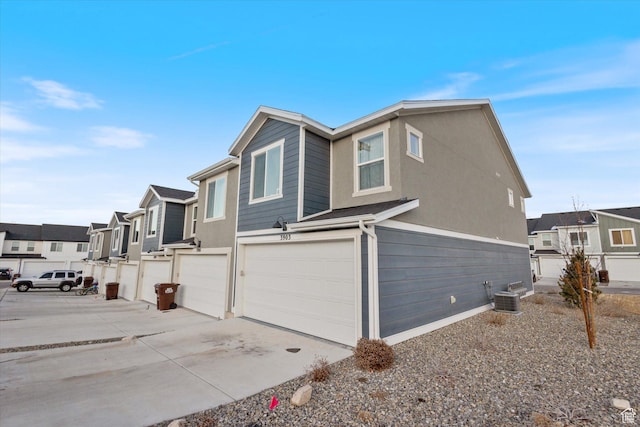 view of home's exterior featuring a garage and central AC