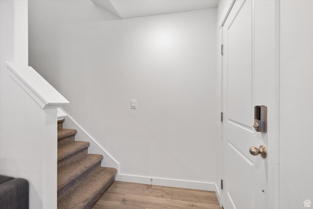 stairs with hardwood / wood-style flooring