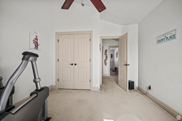 workout area with lofted ceiling, light colored carpet, and ceiling fan