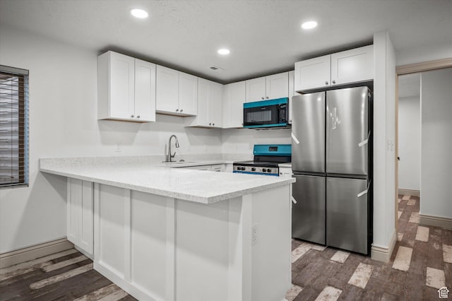 kitchen with white cabinetry, sink, dark wood-type flooring, and stainless steel appliances
