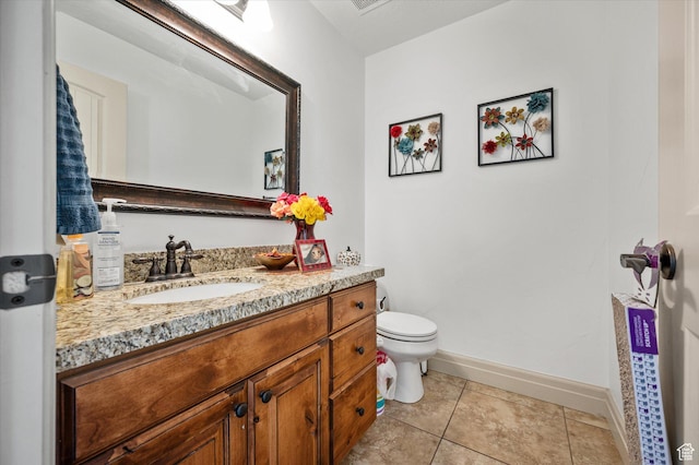 bathroom with vanity, toilet, and tile patterned flooring