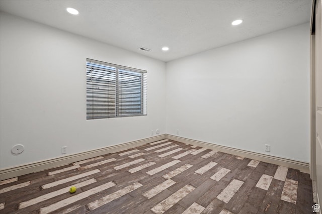 empty room featuring hardwood / wood-style flooring