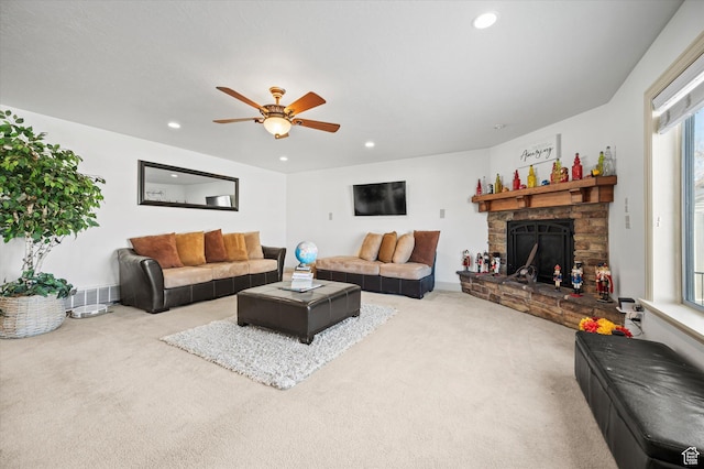 living room featuring a fireplace, carpet floors, and ceiling fan