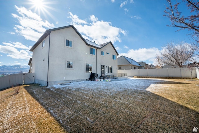 rear view of property featuring a patio and a lawn