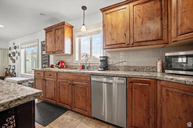 kitchen featuring sink, light tile patterned floors, stainless steel appliances, tasteful backsplash, and light stone counters