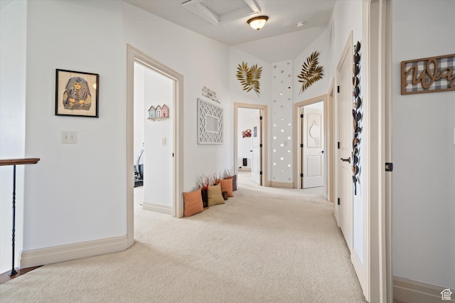 corridor with light colored carpet
