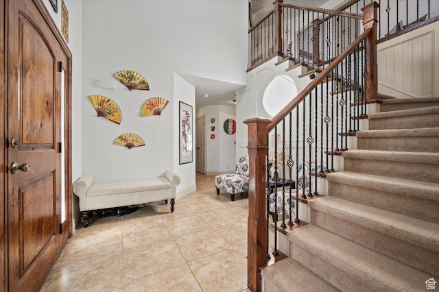 foyer featuring a high ceiling and light tile patterned flooring