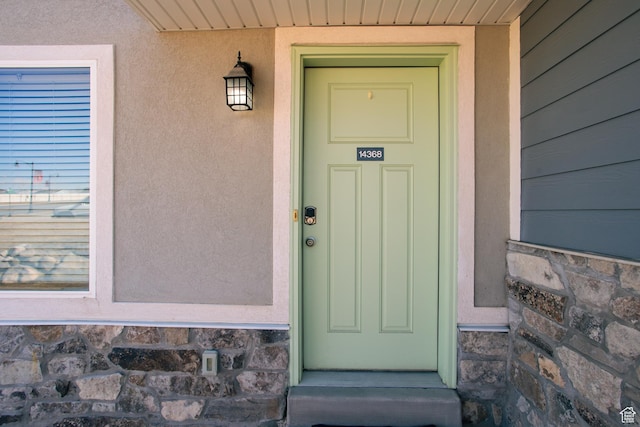 14368 S Penrhy Ct, Herriman, UT 84096 - doorway to property with stone siding and stucco siding