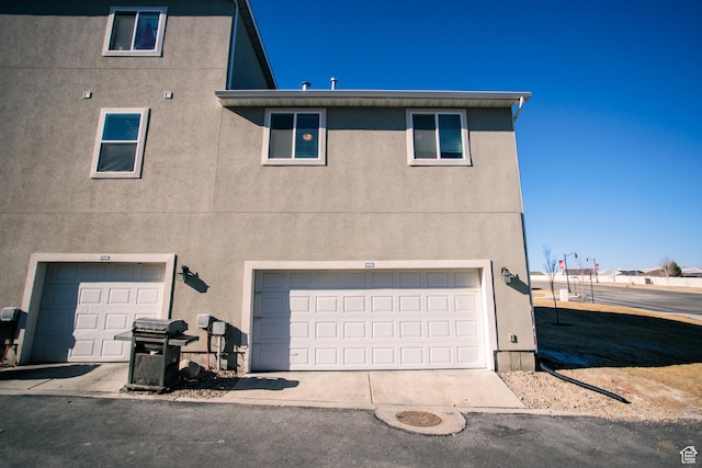 14368 S Penrhy Ct, Herriman, UT 84096 - back of property featuring stucco siding and an attached garage