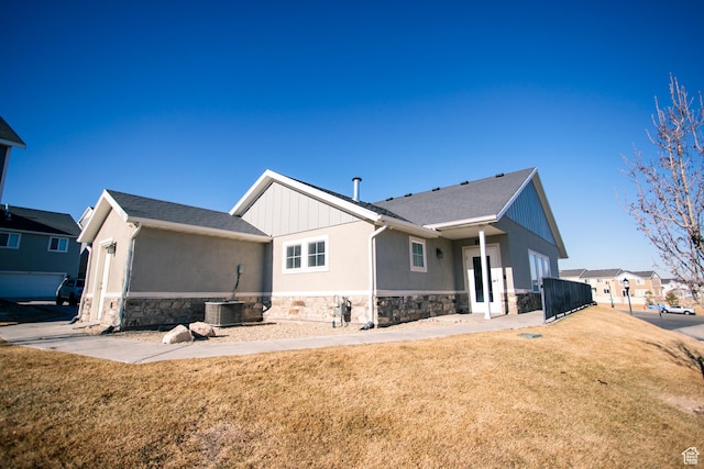 14368 S Penrhy Ct, Herriman, UT 84096 - rear view of property featuring stone siding, a yard, and stucco siding