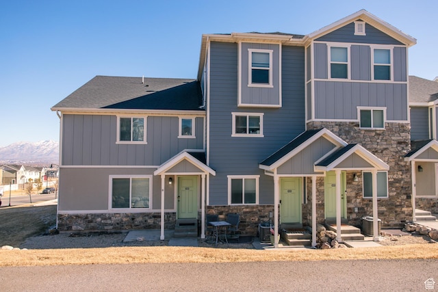 view of front of house featuring a mountain view and central air condition unit