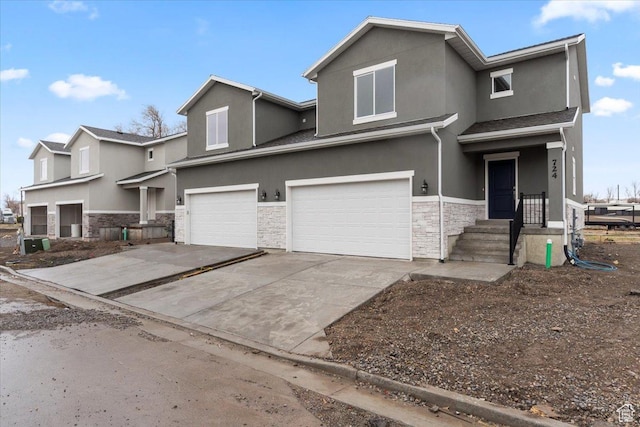 view of front of property with stone siding, stucco siding, an attached garage, and driveway
