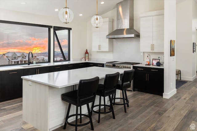 3450 N 1930 E, North Logan, UT 84341 - kitchen with pendant lighting, wall chimney range hood, sink, a breakfast bar area, and a center island