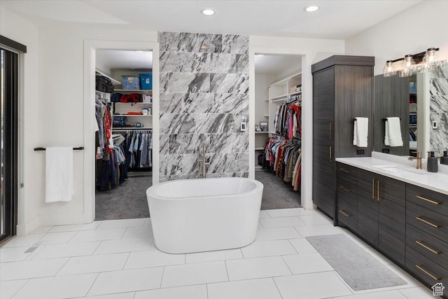 3450 N 1930 E, North Logan, UT 84341 - bathroom featuring tile patterned floors, vanity, a bathtub, and tile walls