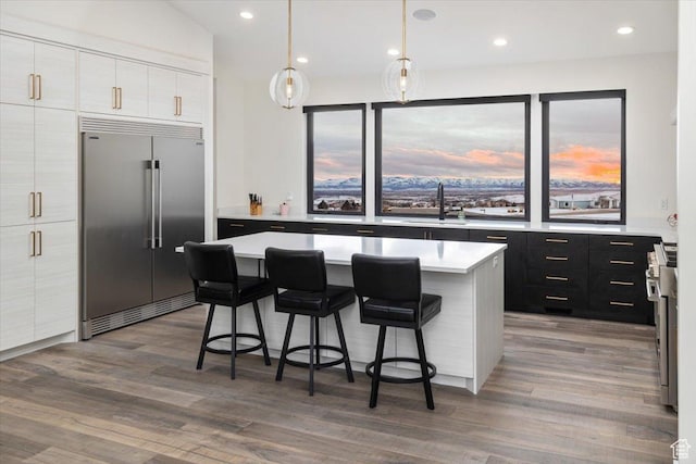 3450 N 1930 E, North Logan, UT 84341 - kitchen with stainless steel built in refrigerator, a kitchen bar, sink, a center island, and hanging light fixtures