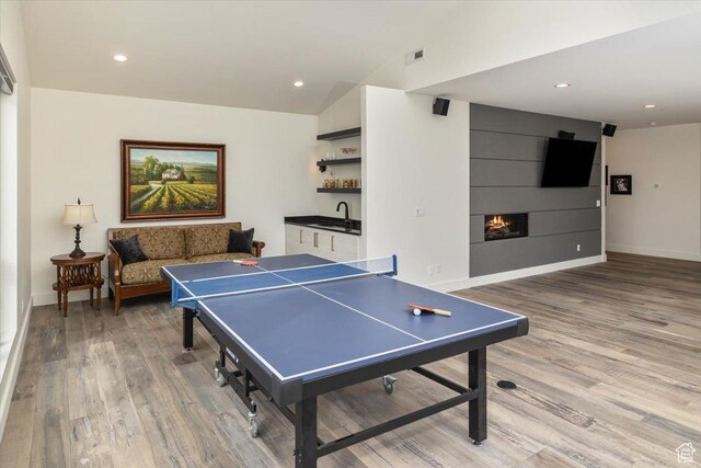 3450 N 1930 E, North Logan, UT 84341 - playroom featuring a large fireplace, lofted ceiling, wet bar, and hardwood / wood-style floors