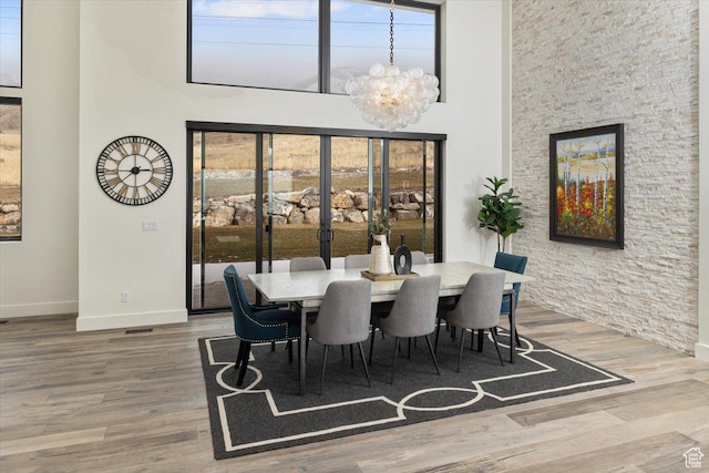 3450 N 1930 E, North Logan, UT 84341 - dining room with a high ceiling, wood-type flooring, and a notable chandelier