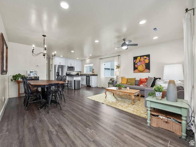 1802 E Magnolia Cir, Eagle Mountain, UT 84005 - living room featuring ceiling fan with notable chandelier and dark hardwood / wood-style floors