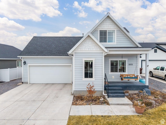 view of front of property featuring a porch and a garage