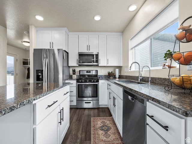 1802 E Magnolia Cir, Eagle Mountain, UT 84005 - kitchen featuring sink, dark wood-type flooring, stainless steel appliances, and white cabinets