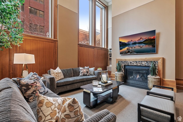 99 W S Temple St S Unit 2201, Salt Lake City, UT 84101 - living room with a high ceiling, carpet floors, a high end fireplace, and wooden walls