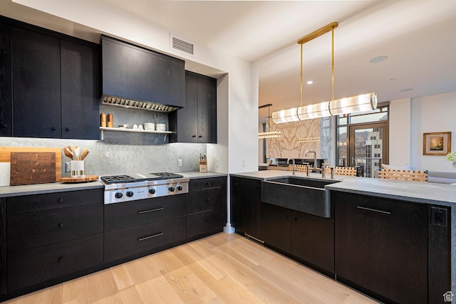 99 W S Temple St S Unit 2201, Salt Lake City, UT 84101 - kitchen featuring sink, light hardwood / wood-style flooring, stainless steel gas cooktop, and decorative light fixtures