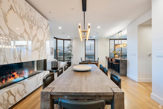 99 W S Temple St S Unit 2201, Salt Lake City, UT 84101 - dining space with a fireplace, a wall of windows, and light hardwood / wood-style floors
