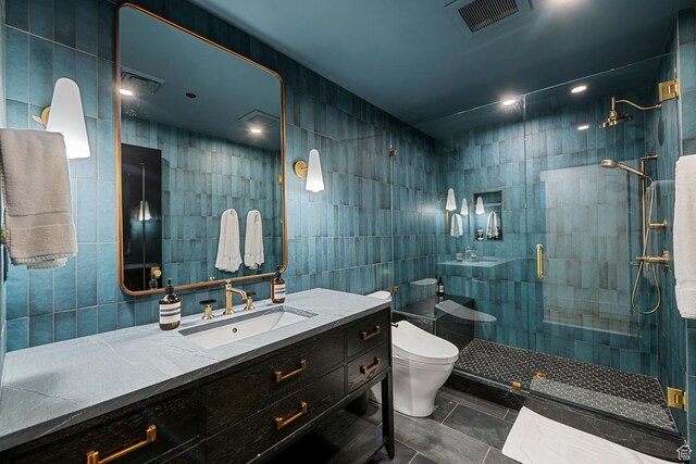 99 W S Temple St S Unit 2201, Salt Lake City, UT 84101 - bathroom with tile patterned flooring, toilet, a shower with shower door, tile walls, and vanity