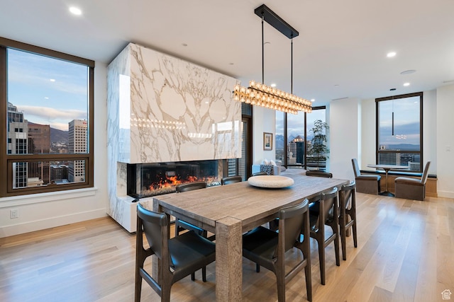 99 W S Temple St S Unit 2201, Salt Lake City, UT 84101 - dining area featuring light wood-type flooring and a premium fireplace